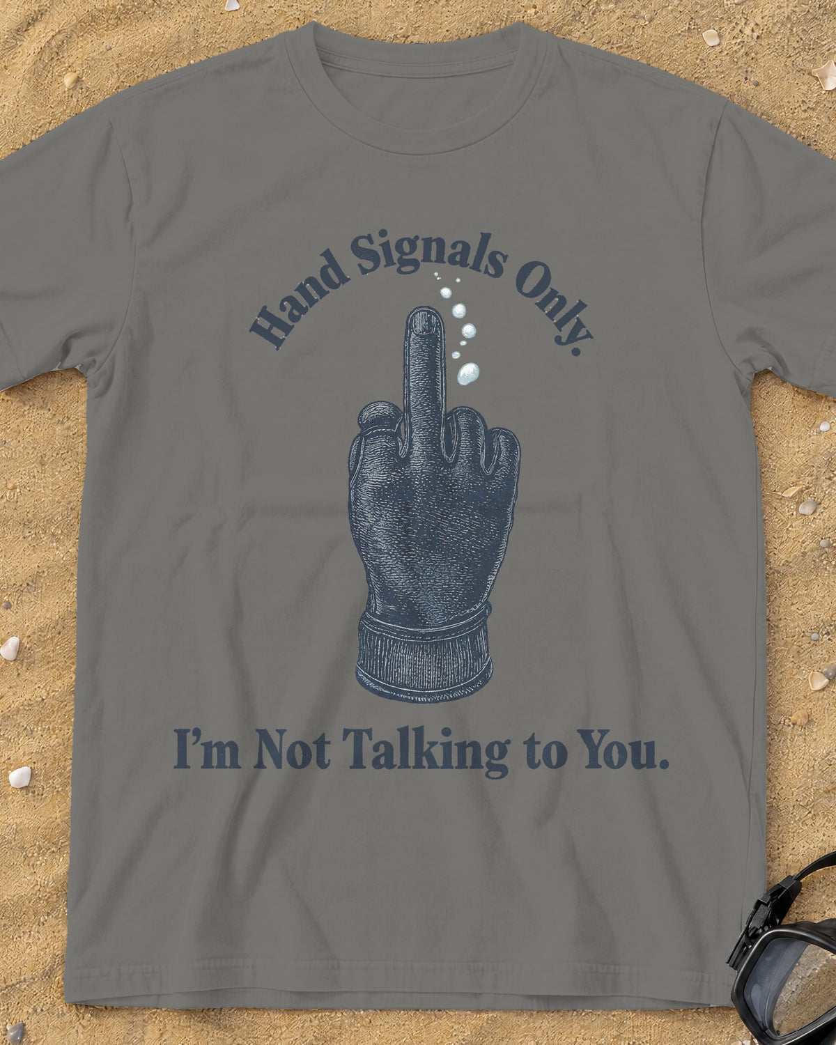 Grey Hand Signals Only tee on a sandy beach