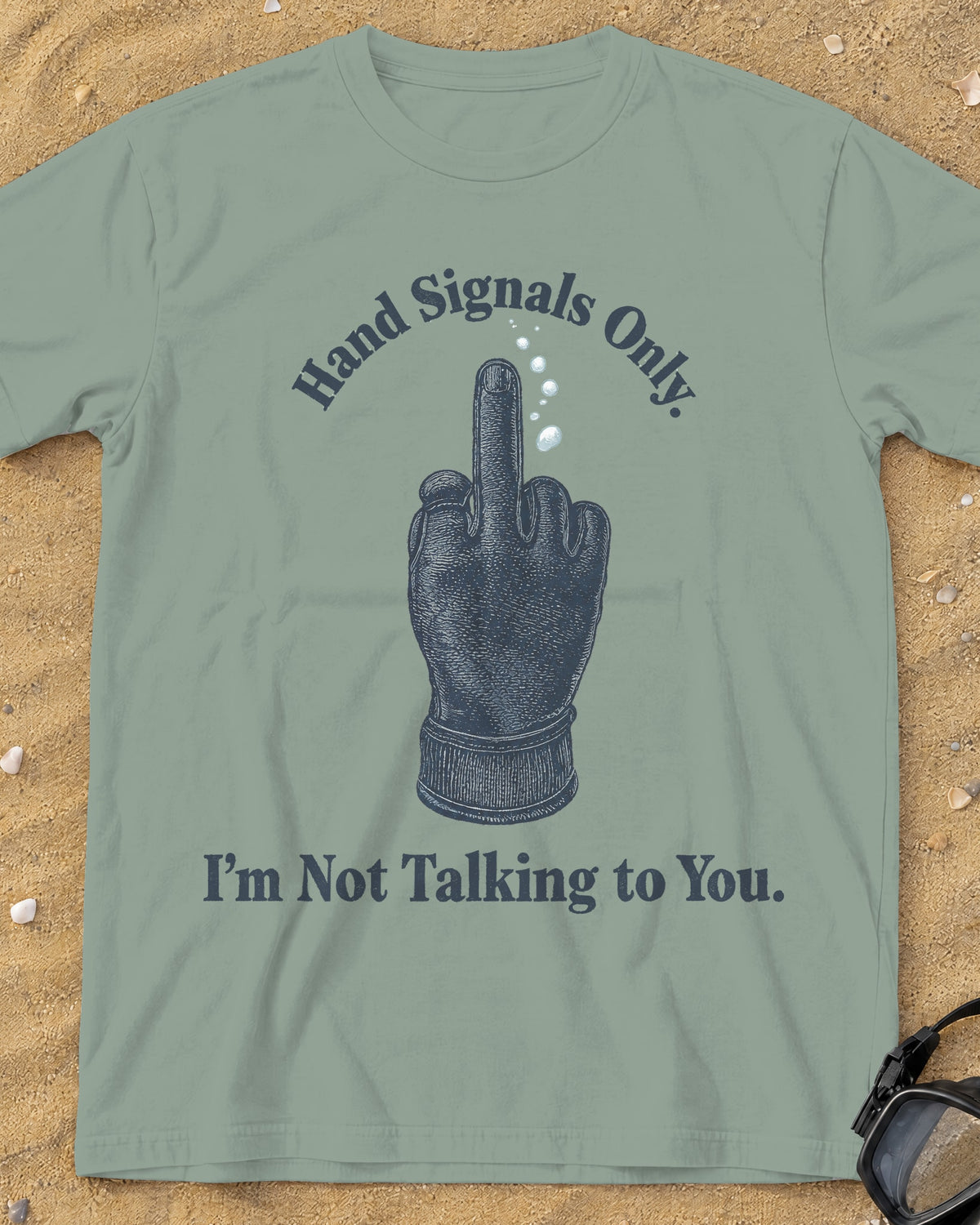 Bay Hand Signals Only tee on a sandy beach