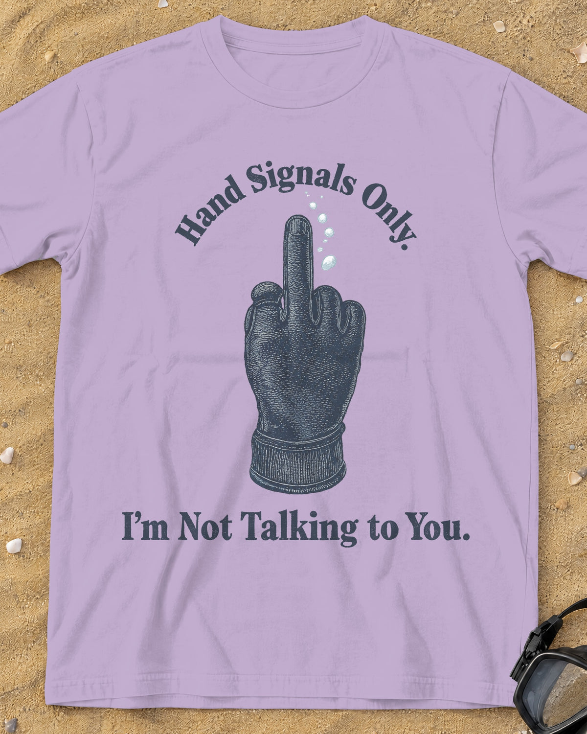 Orchid Hand Signals Only tee on a sandy beach