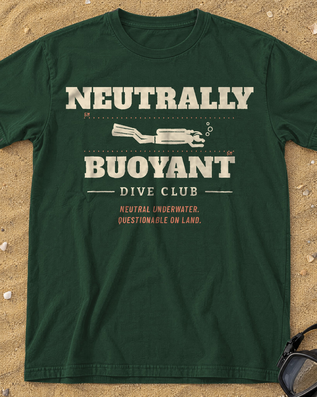 Moss Neutrally Buoyant Dive Club tee on a sandy beach